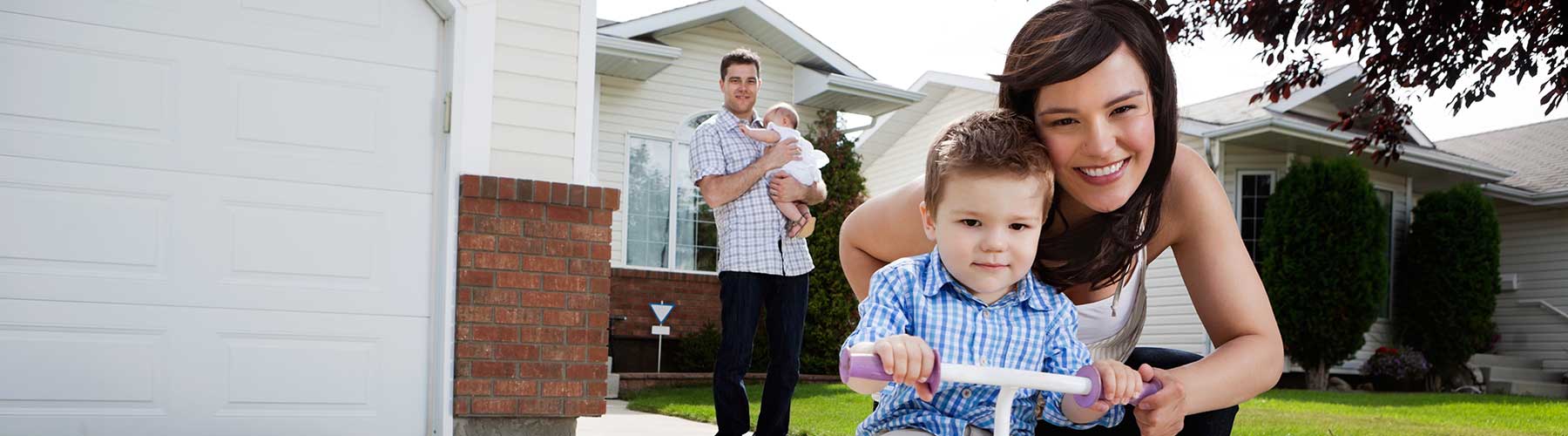 Personal insurance represented by family posing in front of their home